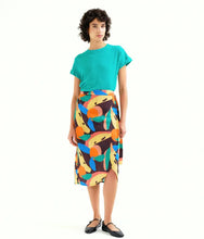 Load image into Gallery viewer, Woman wearing a turquoise top and colorful skirt on a white background