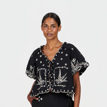Load image into Gallery viewer, Woman wearing a black blouse with white bird patterns on a plain background
