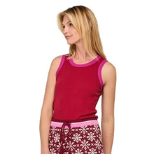 Load image into Gallery viewer, A woman modeling a two-piece loungewear set consisting of a sleeveless magenta top and matching patterned pants in burgundy and white, paired with colorful sneakers, against a light gray studio background.
