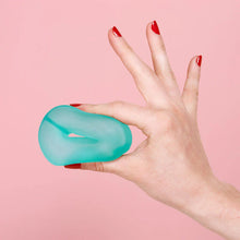 Load image into Gallery viewer, Hand holding a teal gel roller against a pink background

